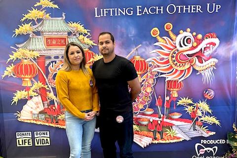 Ricardo and Yadira stand together against an event backdrop.